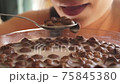 woman, mouth eating chocolate cereals in milk close 75845380