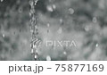 Tilt down shot of fountain jet and drops of falling water disturbing water surface 75877169