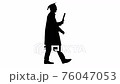 Silhouette Happy male student in graduation robe walking and kissing his diploma. 76047053
