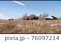 Several military vehicles are firing rocket weapons, leaving a lot of smoke. Combat operations of military equipment, daytime shooting 76097214