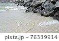 Coastal waves of the Persian Gulf near a stone embankment, UAE 76339914