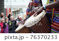 Man playing drum by his hands. Street performance using percussion instruments in slow motion 76370233