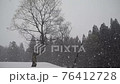 Snowstorm in a snowy country 76412728
