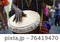 Man playing drum by his hands. Street performance using percussion instruments in slow motion 76419470