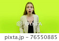 Irritable woman angry face in space studio demonstrating shut up 76550885