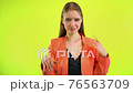 Woman ignoring man in space studio on yellow background 76563709