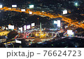 time lapse aerial view of Victory monument, famous landmark center of Bangkok city, Thailand, at night and heavy traffic jam transportation at roundabout and on highway, motorway, tollway business 76624723