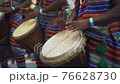 Man playing drum by his hands. Street performance using percussion instruments in slow motion 76628730