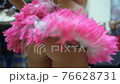 Celebration of Brazilian carnival. Beautiful girl in colorful festive costume decorated with rhinestones and feathers are dancing samba at street. Slow motion 76628731