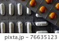 Tablets in blister packs on black background 76635123