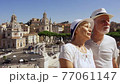 Seniors in hats on Venice square in Rome city. Retired pensioners travel through Europe together 77061147