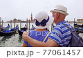 Retired senior couple enjoy vacation in Venice. Back view of toutists pensioners look at Grand canal 77061457