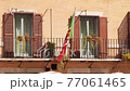 Italian Republic flag with coat of arms in middle stripe waving in wind. Green-white-red banner hang 77061465