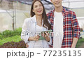 Smart farm and farm technology concept.Smart young asian farmer using tablet to check quality and quantity of organic hydroponic vegetable garden at greenhouse . 77235135