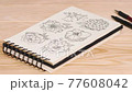 Sketchbook on a table with pencils. Sketch art, composition of wild flowers 77608042