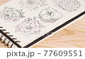 Composition of wild flowers in sketchbook on a table with pencils. 77609551