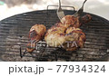 Chicken legs on the barbecue grill 77934324