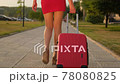 Back view of tourist traveler woman legs in red dress 78080825