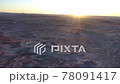 Sunburst on horizon over Utah moonscape 78091417