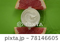 water flowing slow mo on jar of beauty cream with open lid and grapefruit slices 78146605