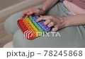 Woman plays with colored silicone antistress toy pop it 78245868