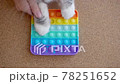 Cat plays with colored silicone antistress toy pop it 78251652