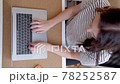 Young woman tired of work and playing pop it. Vertical video 78252587