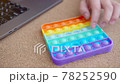 Woman plays with colored silicone antistress toy pop it 78252590