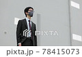 A business person desperately desperately removes the mask due to the corona 78415073