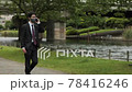 A business person wears a mask and coughs while making a phone call in Kawahara due to Corona 78416246