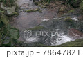 Stream flows down stone ledges covered with green moss 78647821