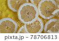 Citrus lemon slices on yellow background moving in water with ripples 78706813