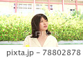 A woman drinking juice 78802878