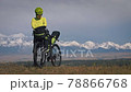 The woman travel on mixed terrain cycle touring with bikepacking. The traveler journey with bicycle bags. Sport tourism bikepacking. The woman travel on mixed terrain cycle touring with bikepacking. The traveler journey with bicycle bags. Sport tourism bikepacking. 78866768