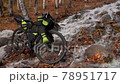 The mixed terrain cycle touring bike with bikepacking.The trip on bike, outdoor in magical autumn forest, river stream. The mixed terrain cycle touring bike with bikepacking.The trip on bike, outdoor in magical autumn forest, river stream. 78951717
