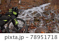 The mixed terrain cycle touring bike with bikepacking.The trip on bike, outdoor in magical autumn forest, river stream. The mixed terrain cycle touring bike with bikepacking.The trip on bike, outdoor in magical autumn forest, river stream. 78951718