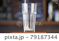 Pour beer into a transparent glass on the bar. Light, golden beer pours into a glass against the backdrop of a bar in a pub. Close up. 79187344