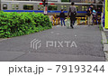 Blurred video. The passing train. A moving pedestrian. Japanese landscape. 79193244