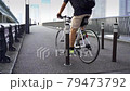 A man riding a bicycle on the sidewalk. Japanese landscape. 79473792