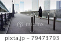 A woman walking on the sidewalk. Japanese landscape. 79473793