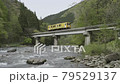 Akita Inland Line running on the fresh green Shimoda Bridge 79529137