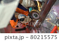 One unrecognizable worker man wear protective gloves, blue jacket uses grinder, saws and turns metal pipe with large diameter into parts at factory background close up view. Sparks fly around guy.  80215575
