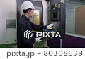An Asian male engineer is monitoring and controlling the machines that are working in the factory. Engineering and industrial concept.	 80308639