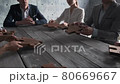 Business people assembling puzzle 80669667