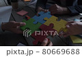 Business people with puzzle and documents 80669688