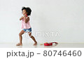 African American little girl have fun with dancing by hold music shaker and stand near ukulele 80746460
