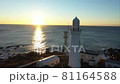 早朝の朝日を浴びる岬の先の白い灯台 81164588