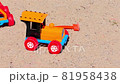 Old Toy Plastic Tractor in The Sand. 81958438