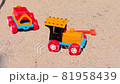 Old Toy Plastic Tractor in The Sand. 81958439