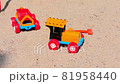 Old Toy Plastic Tractor in The Sand. 81958440